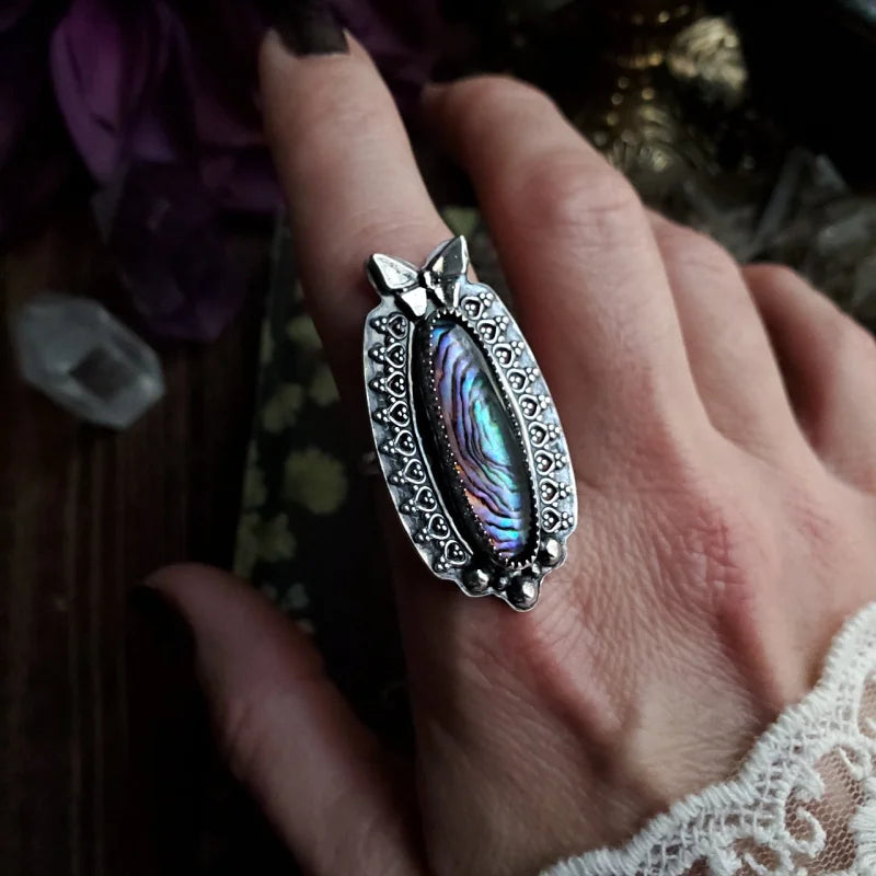 a close up of a person’s hand with a ring on it