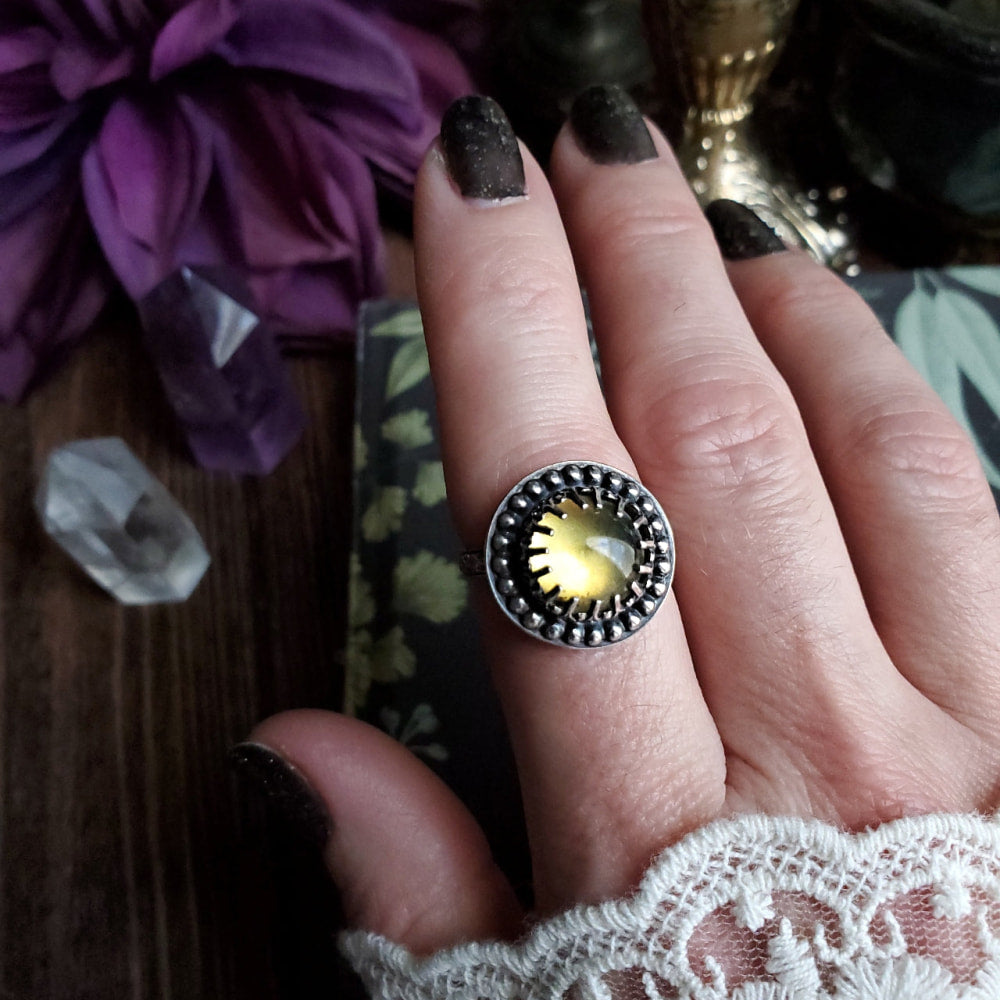 a woman’s hand with a ring on it