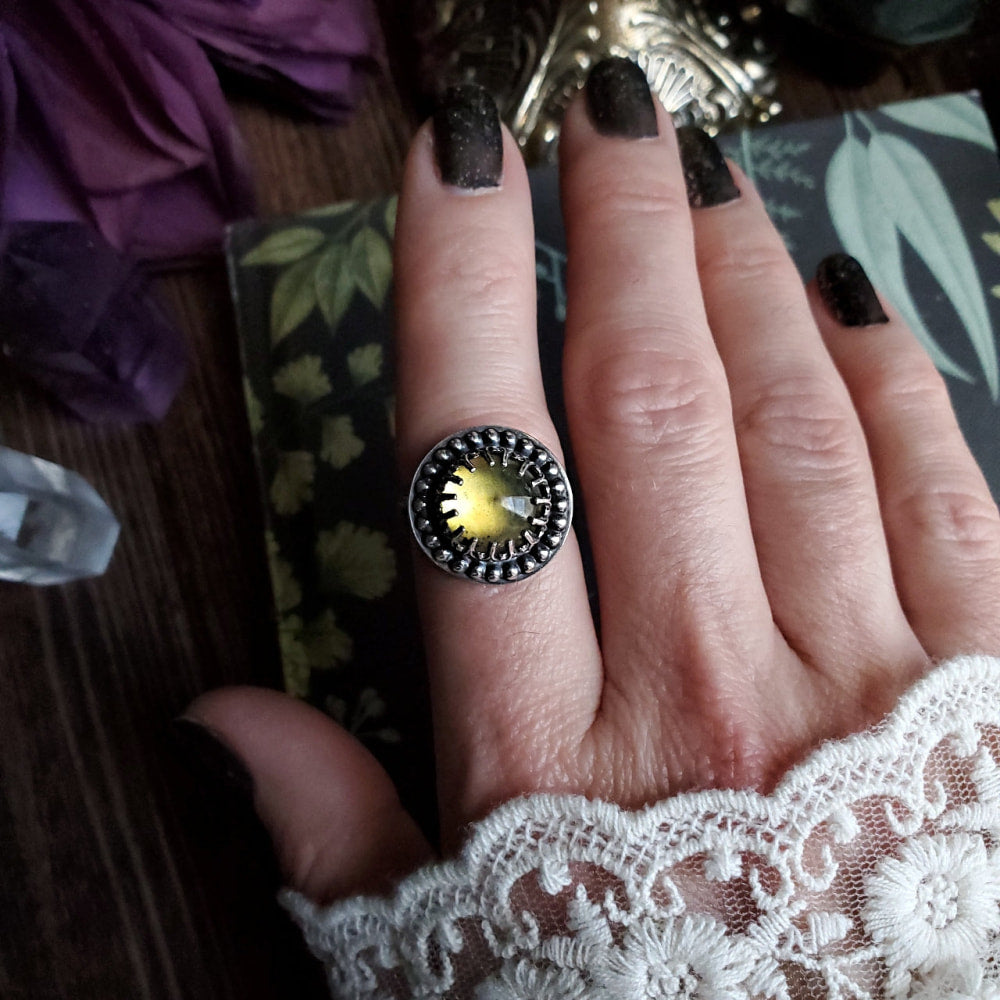 a woman’s hand with a ring on it