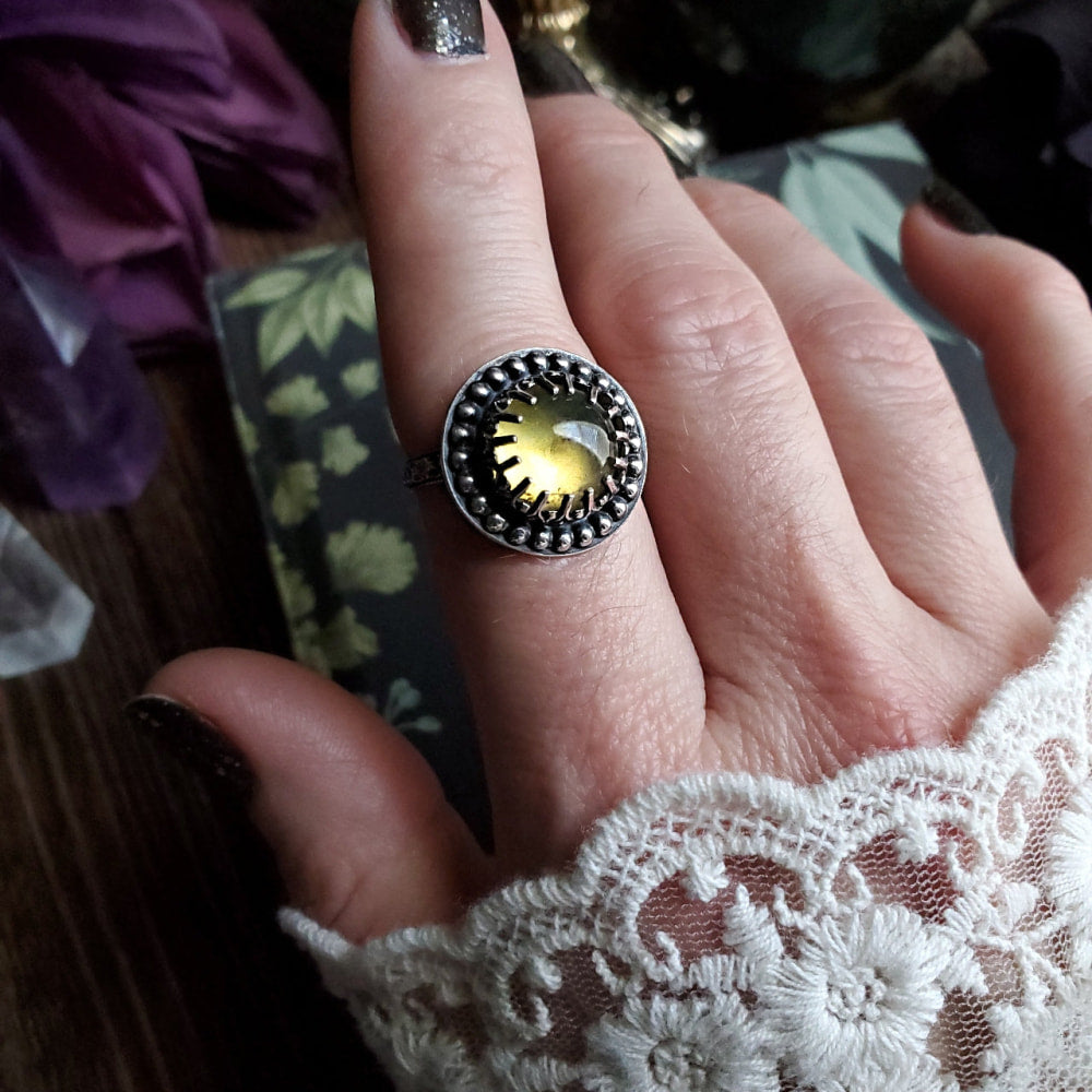 a woman’s hand with a ring on it