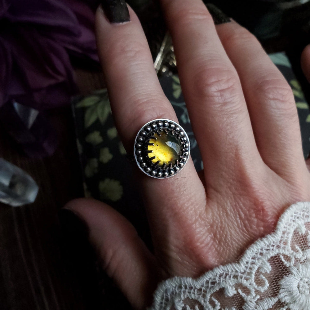 a person’s hand with a ring on it