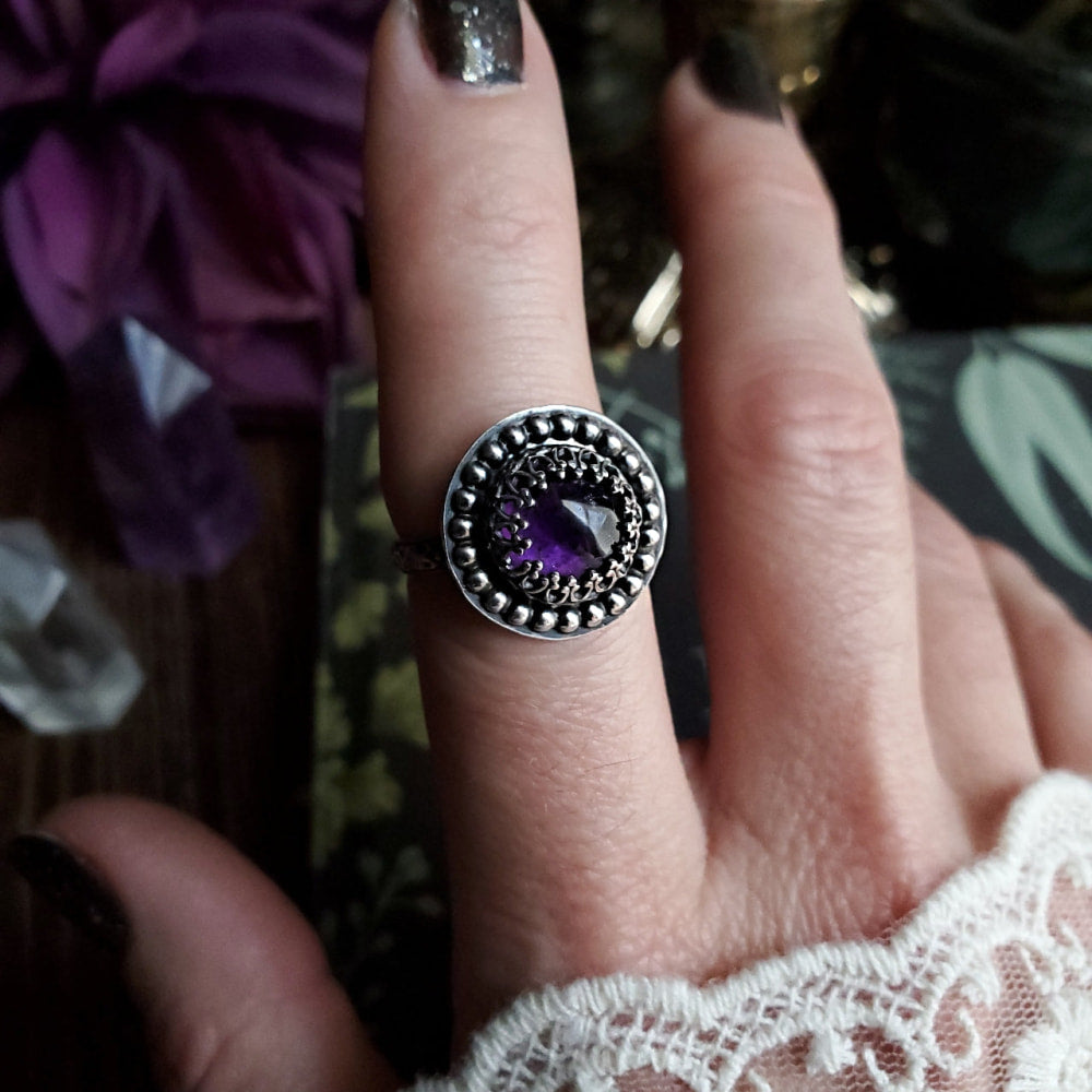 a woman’s hand with a ring on it