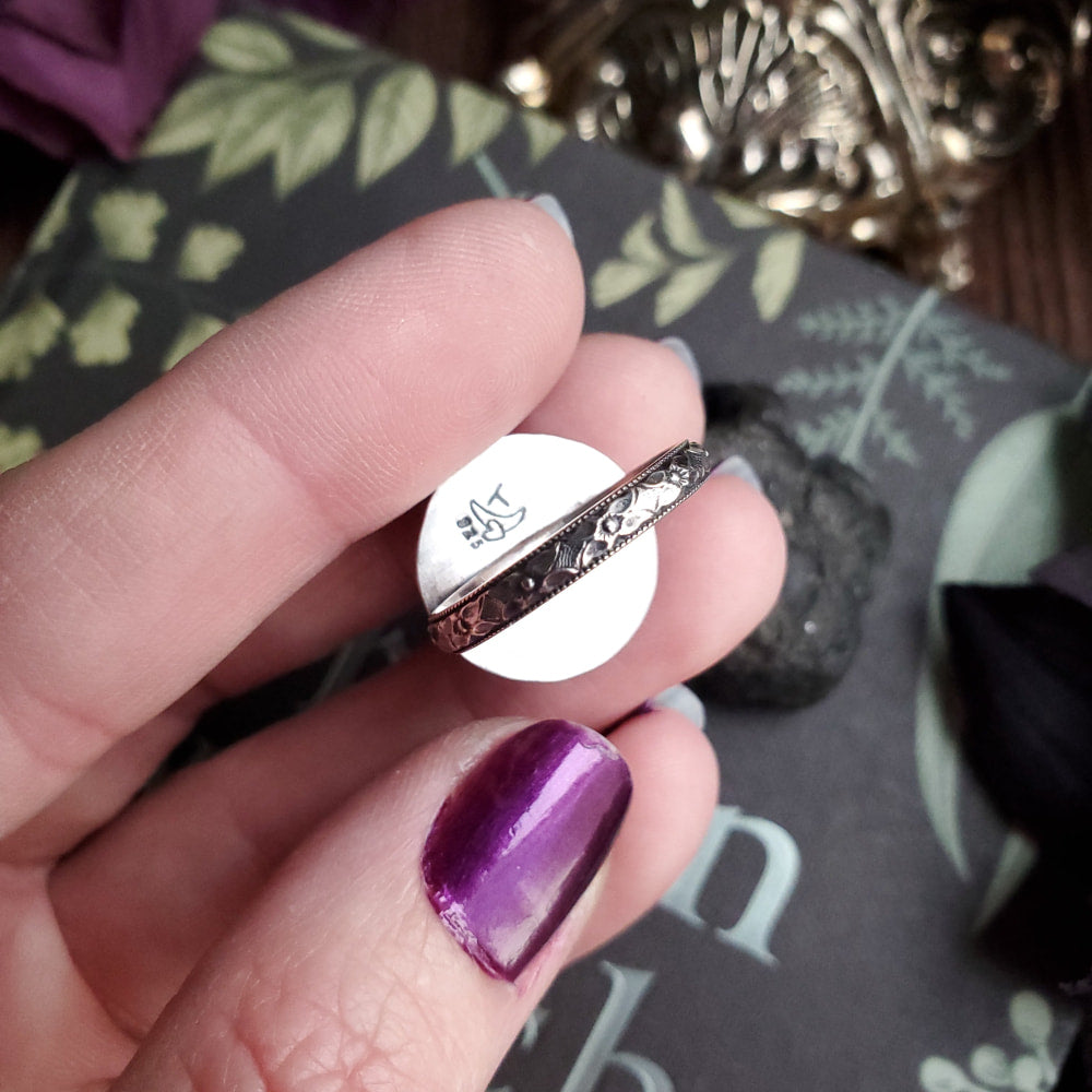 a person holding a purple mani with a purple nail