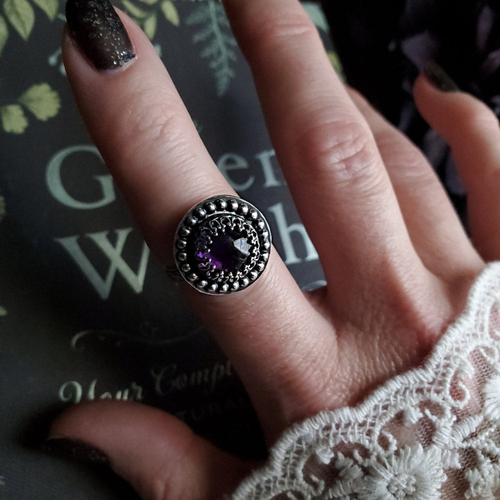 a woman’s hand with a ring on it