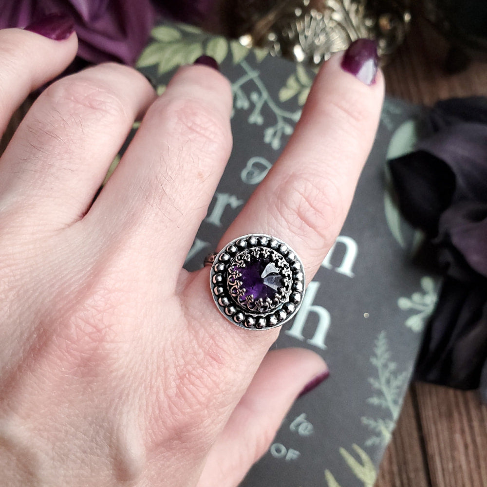 a woman’s hand with a ring on it
