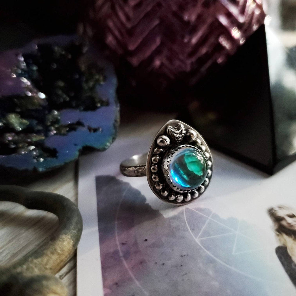 a ring with a green stone on top
