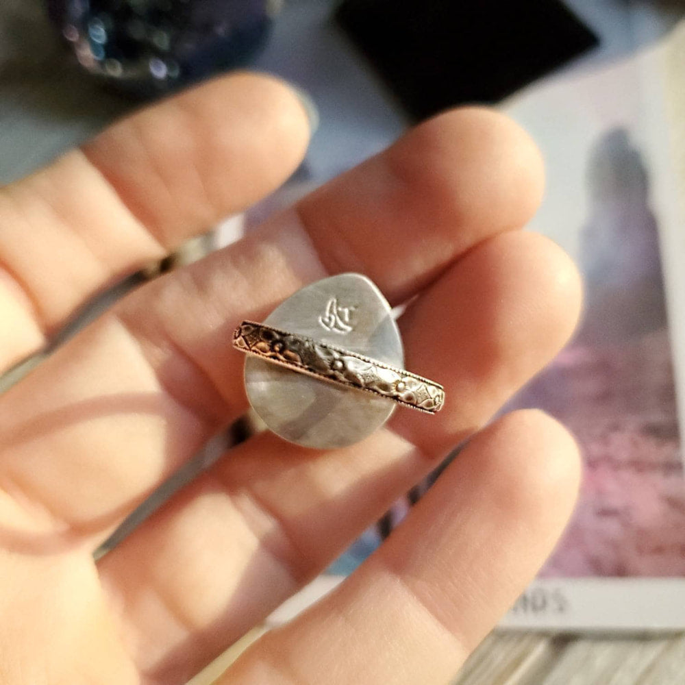 a person holding a ring with a heart on it