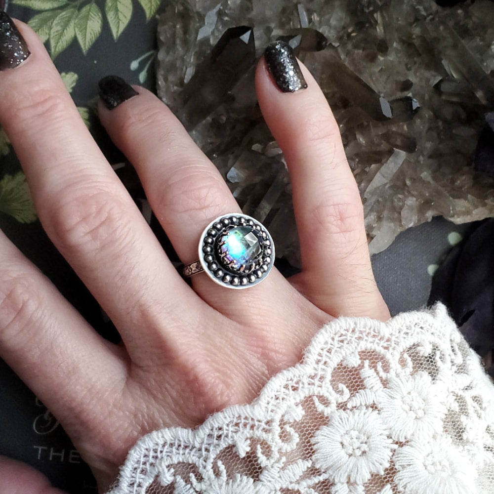 a woman’s hand with a ring on it