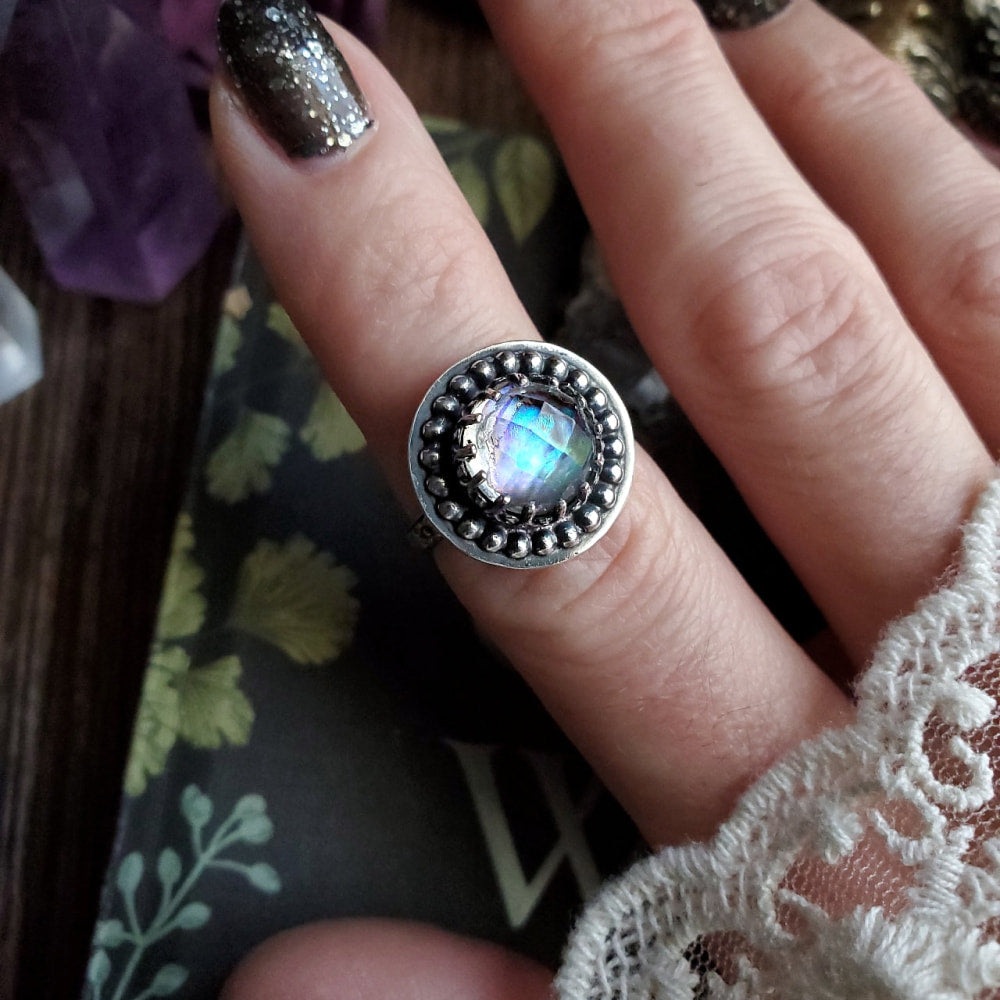 a woman’s hand with a ring on it
