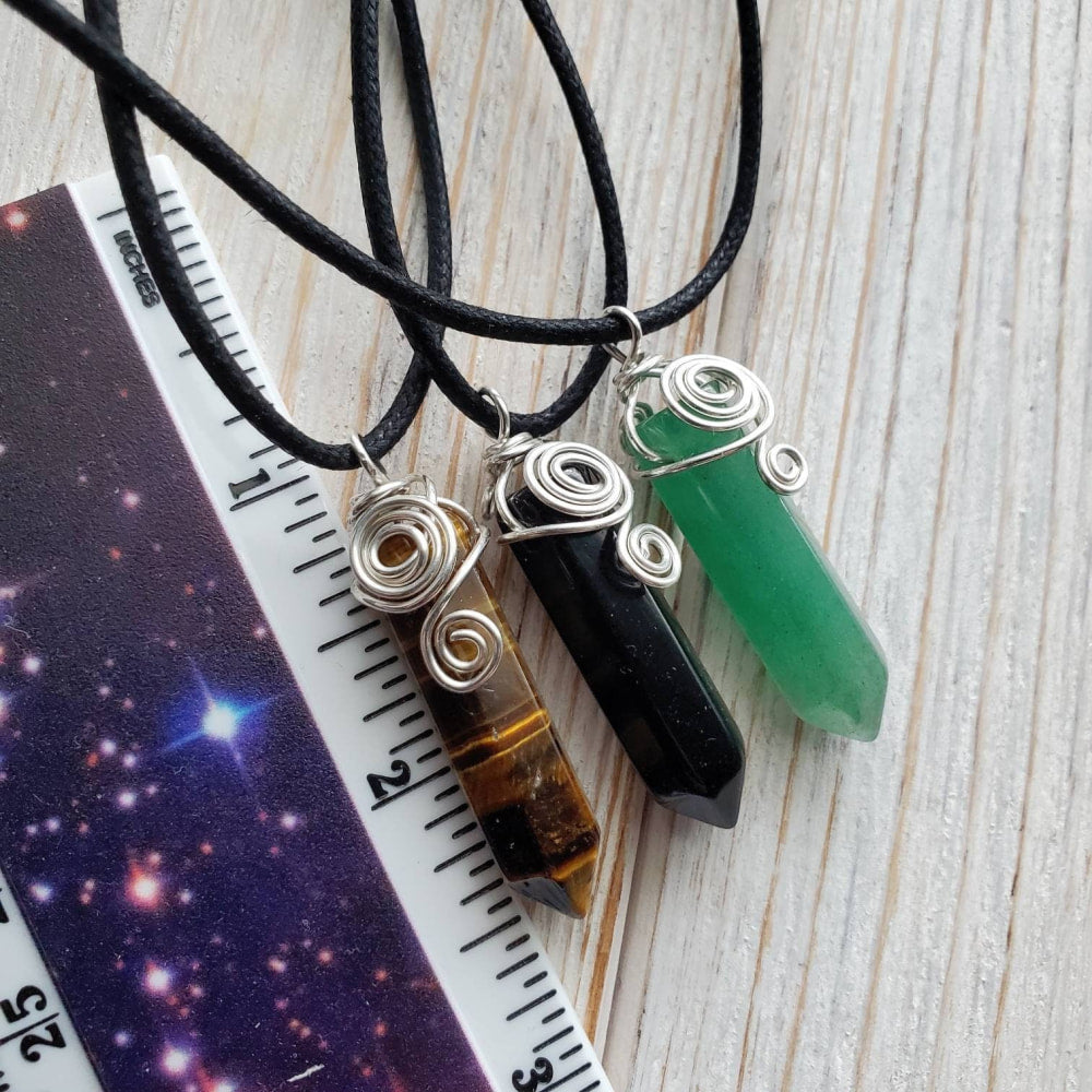 a green quartzite and a black quartzite on a black leather cord necklace