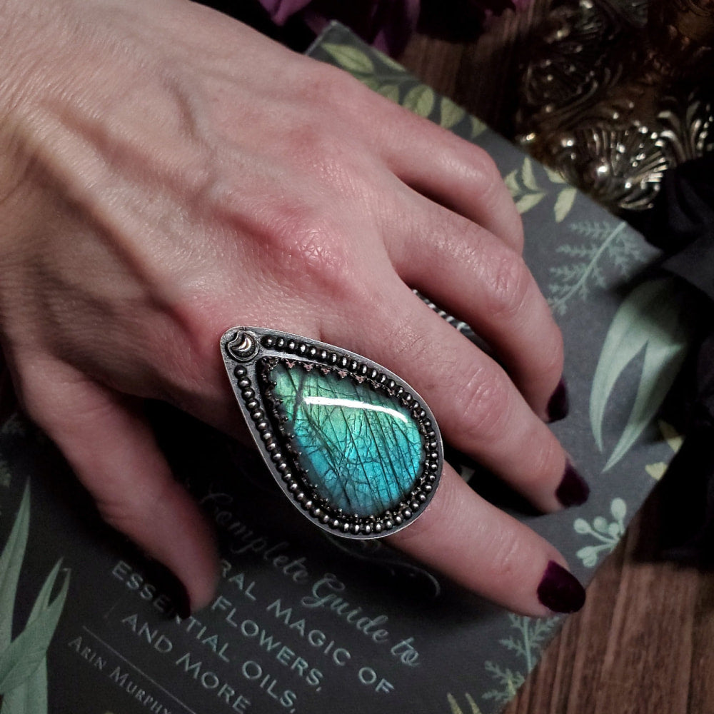 a woman’s hand with a ring on it