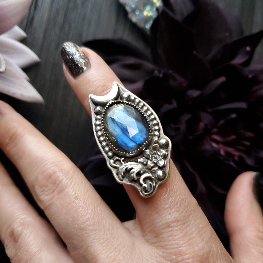 a woman’s hand with a ring on it