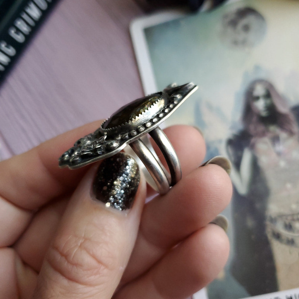 a person holding a ring with a picture of a woman