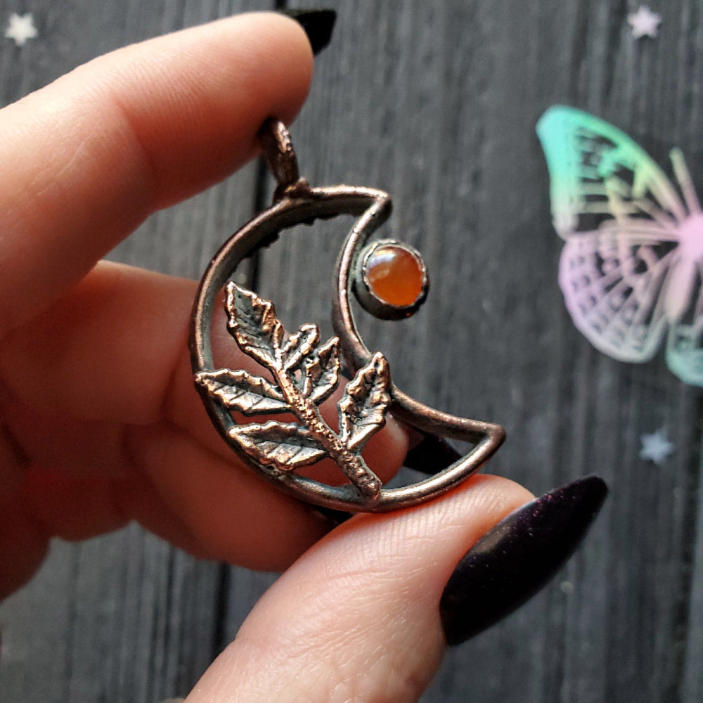 a person holding a ring with a butterfly on it