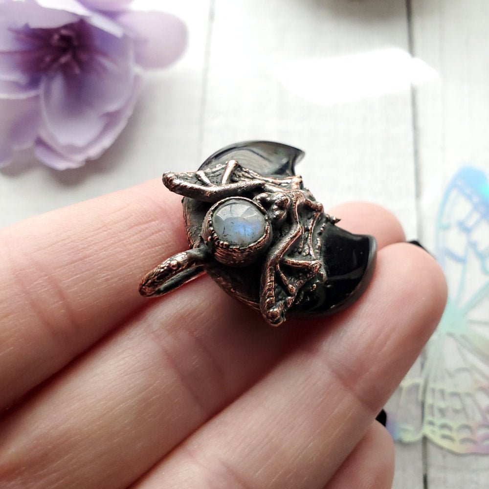 a person holding a ring with a stone