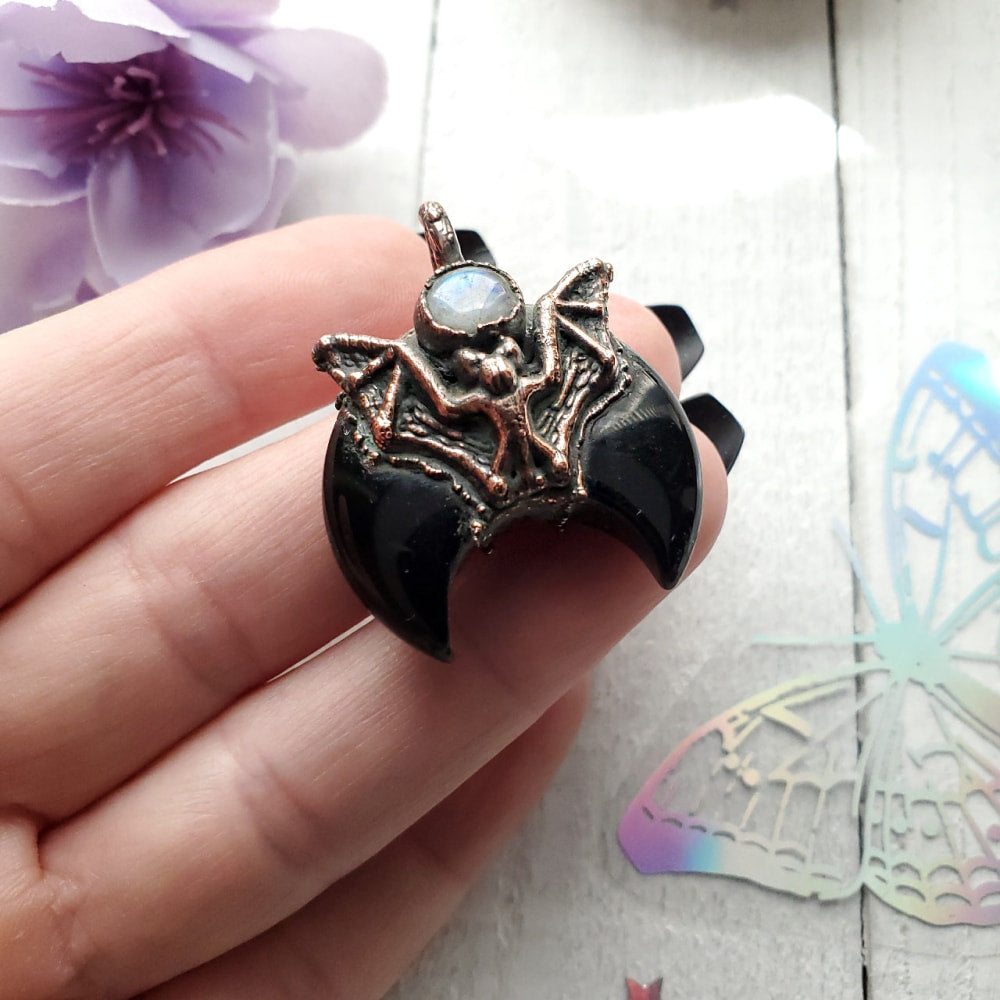 a person holding a ring with a skull on it