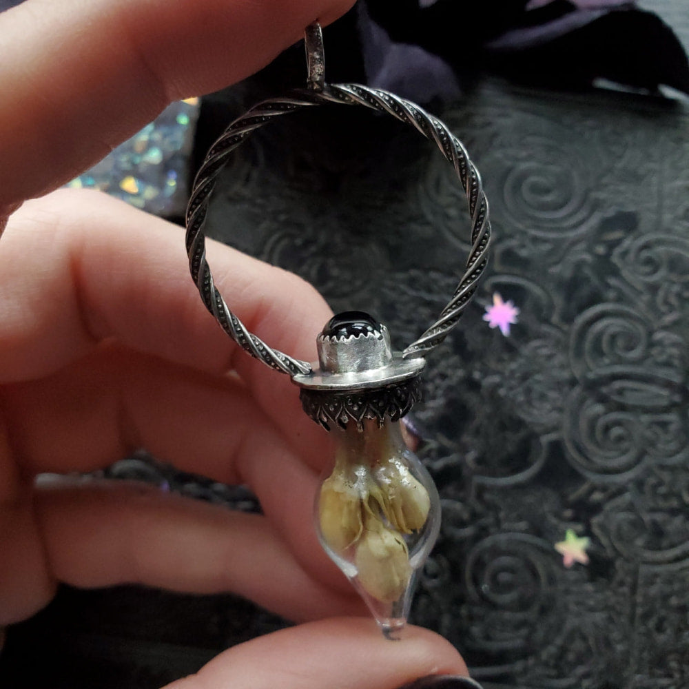 a person holding a ring with a stone inside