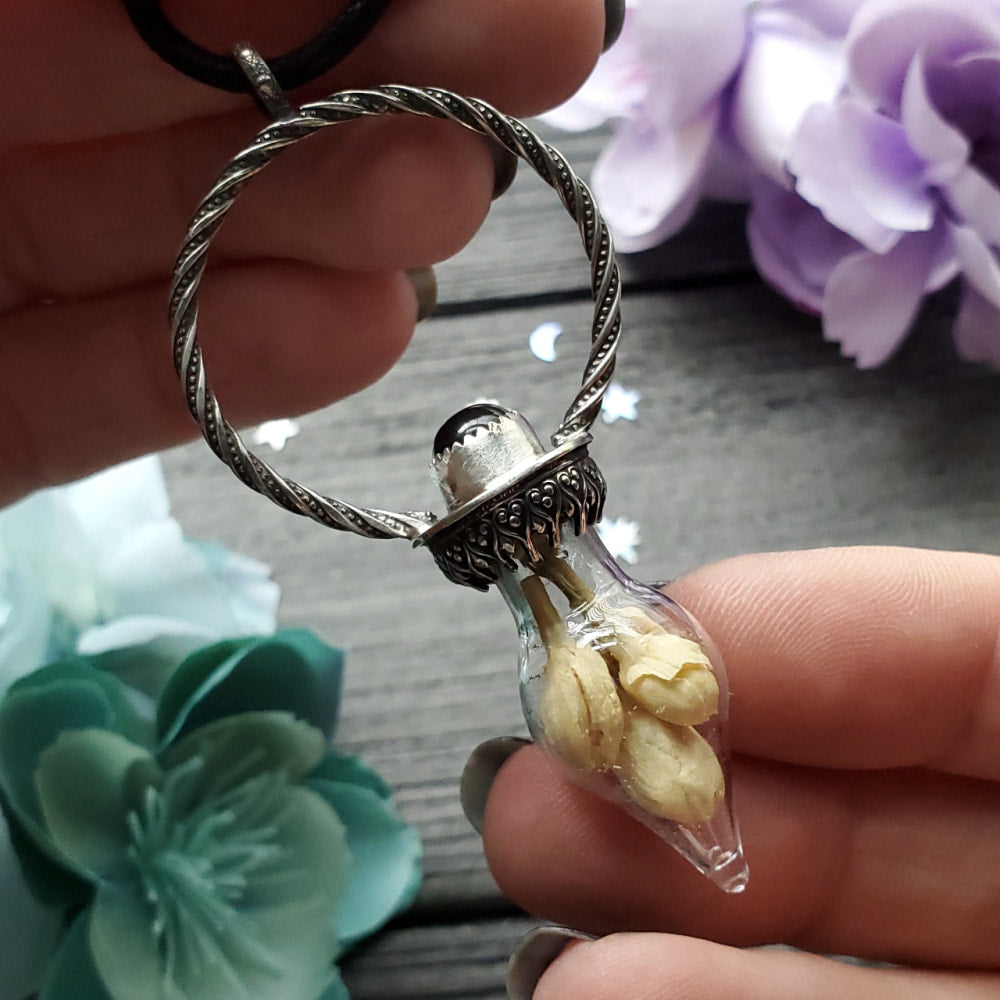 a person holding a ring with a small bird inside