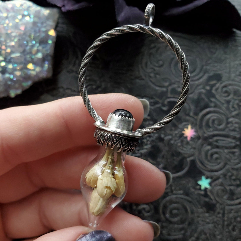 a person holding a ring with a stone inside