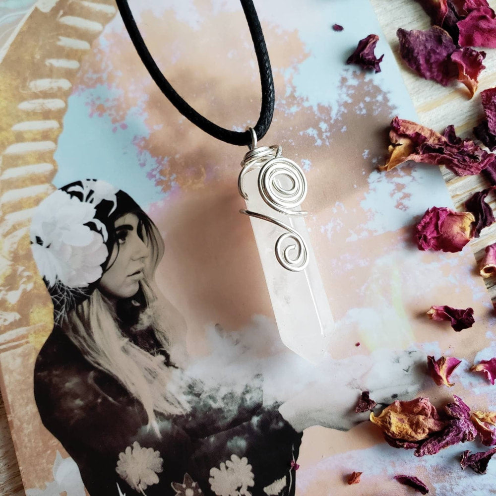 a white pendant with a black and white design on it