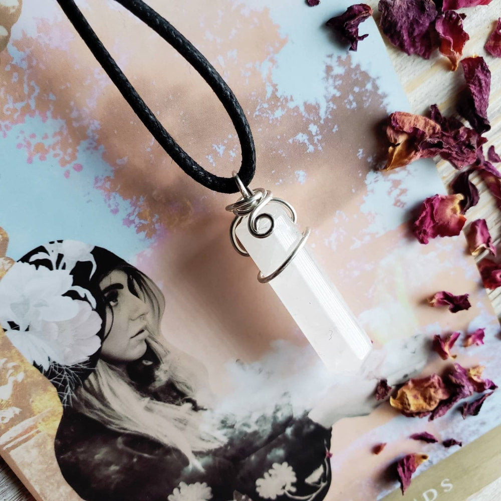 a white necklace with a black and white photo on it