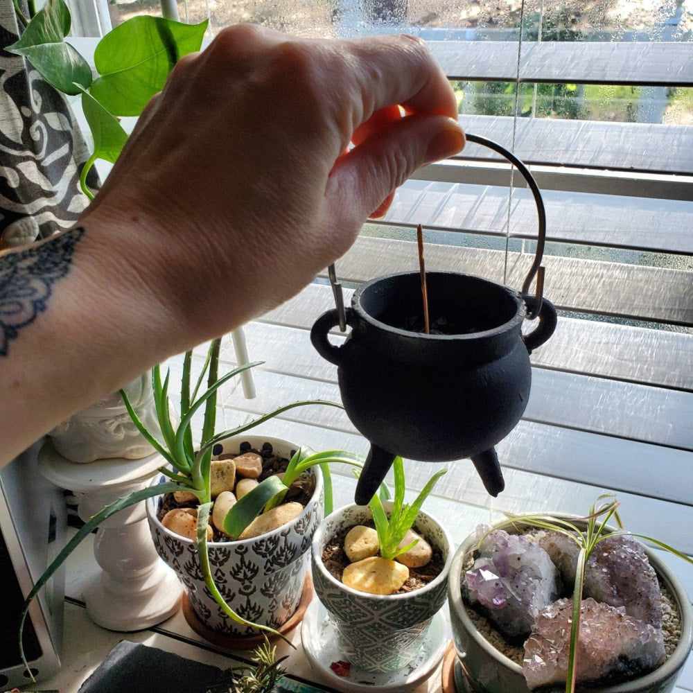 a person is pouring water into a pot