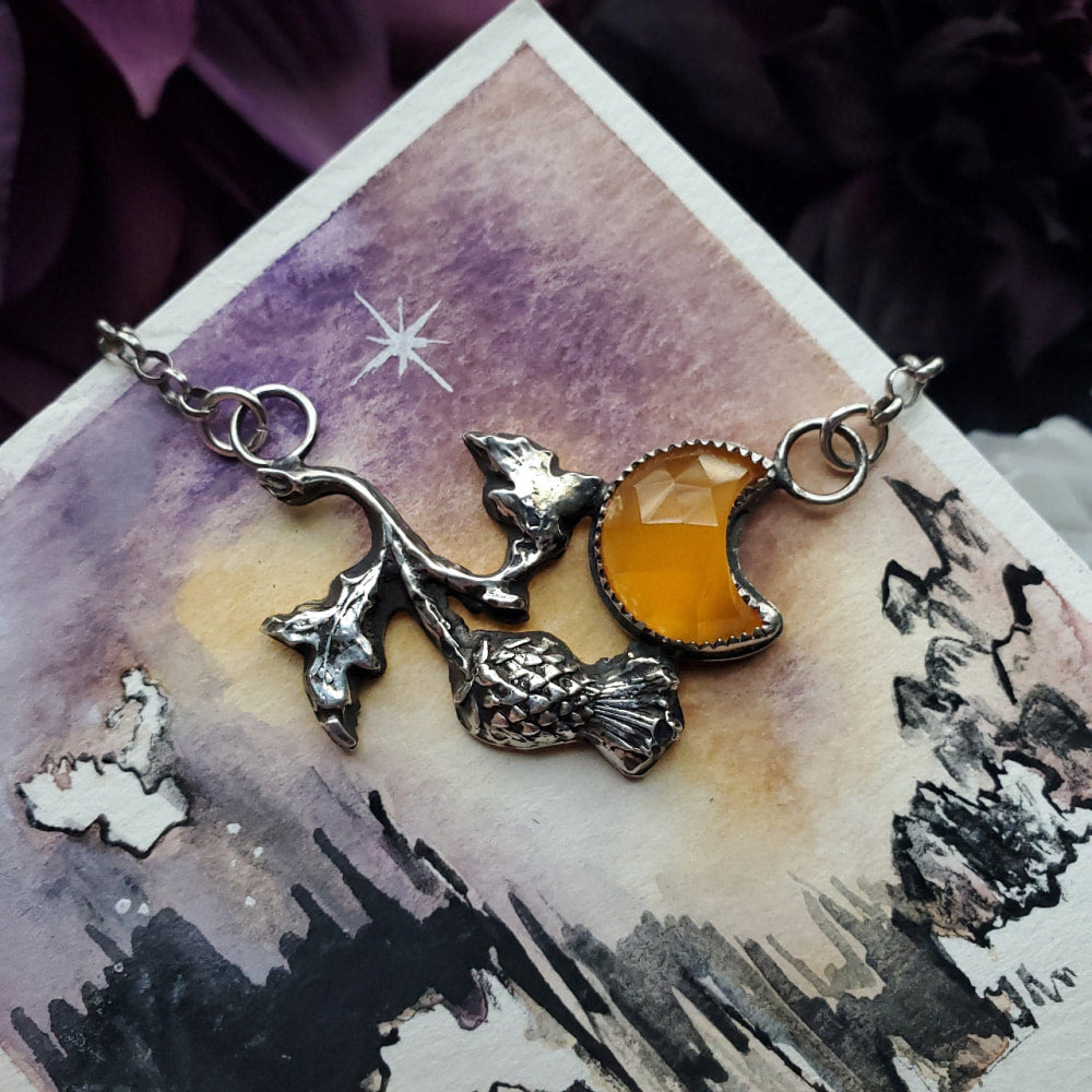 a pair of earrings with a dragon and a star