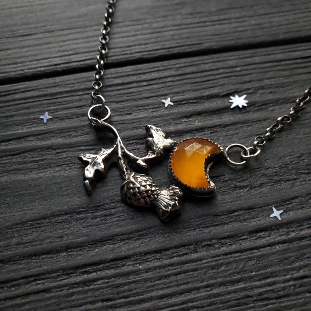 a necklace with a crescent and a star