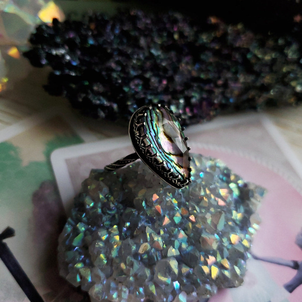 a ring with a rainbow colored stone on top