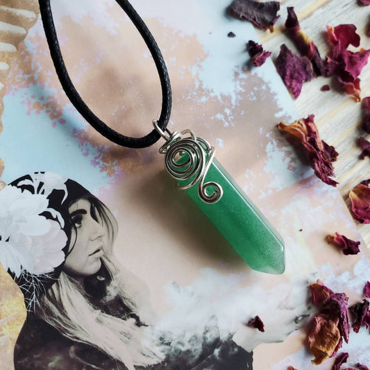 a green avereite stone pendant on a black cord necklace