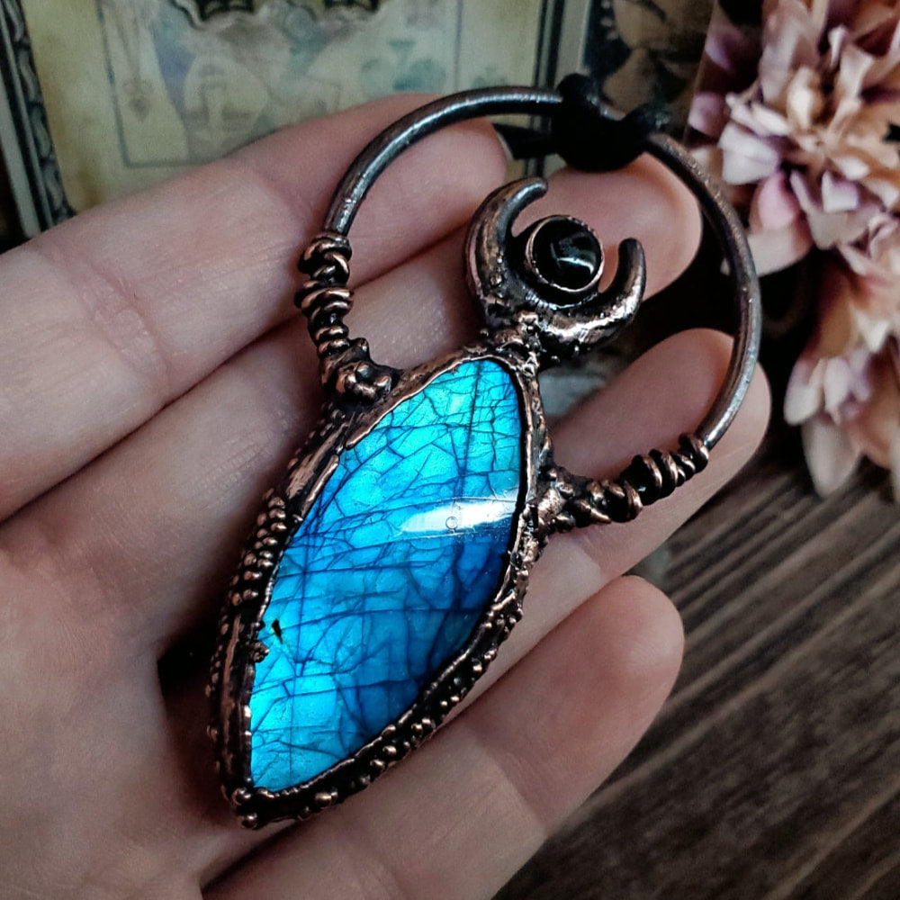 a person holding a blue stone in their hand