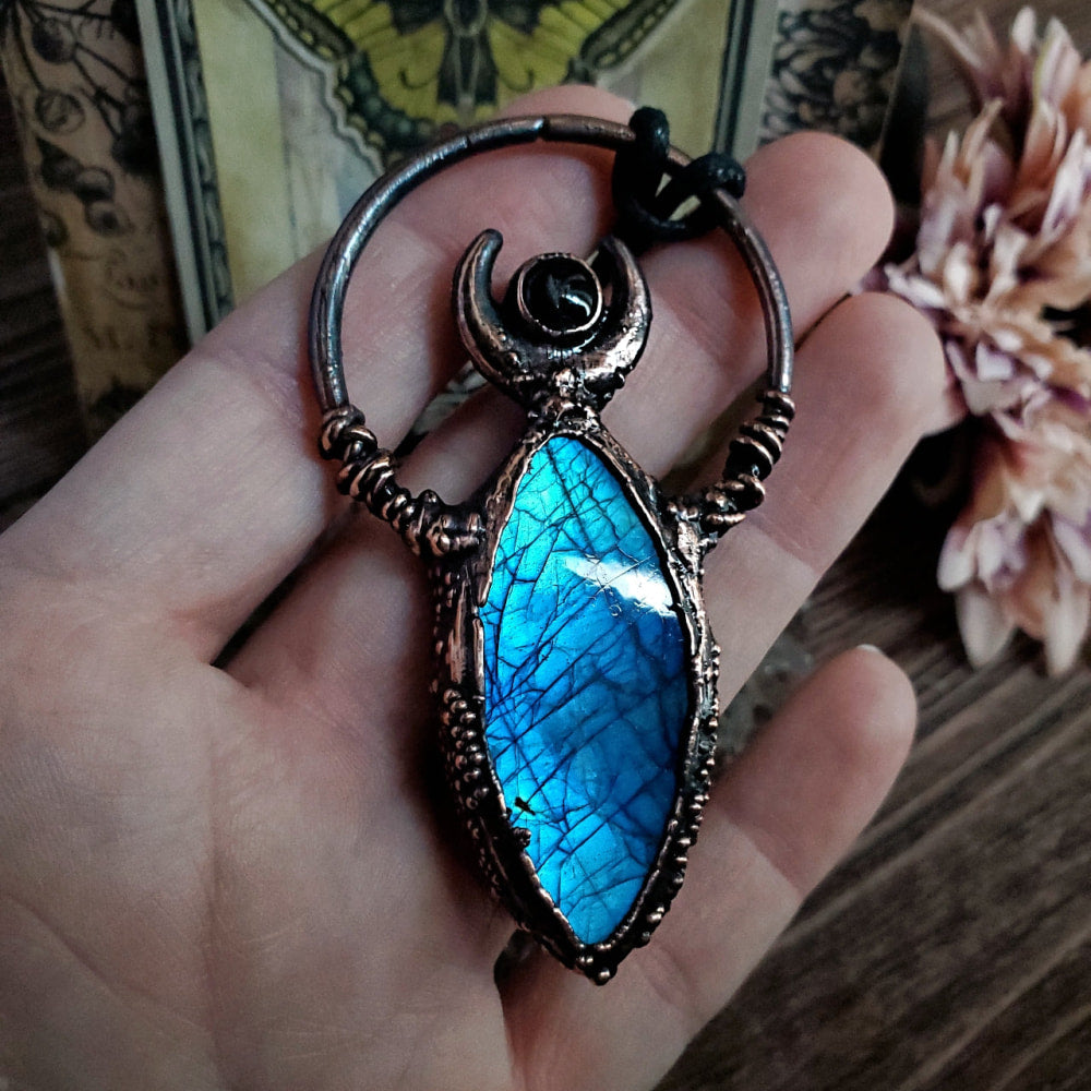 a person holding a blue stone in their hand