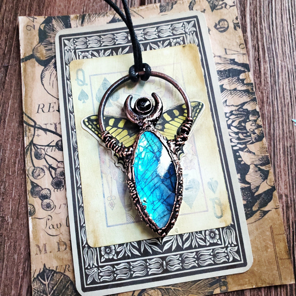 a pendant with a blue stone in the center