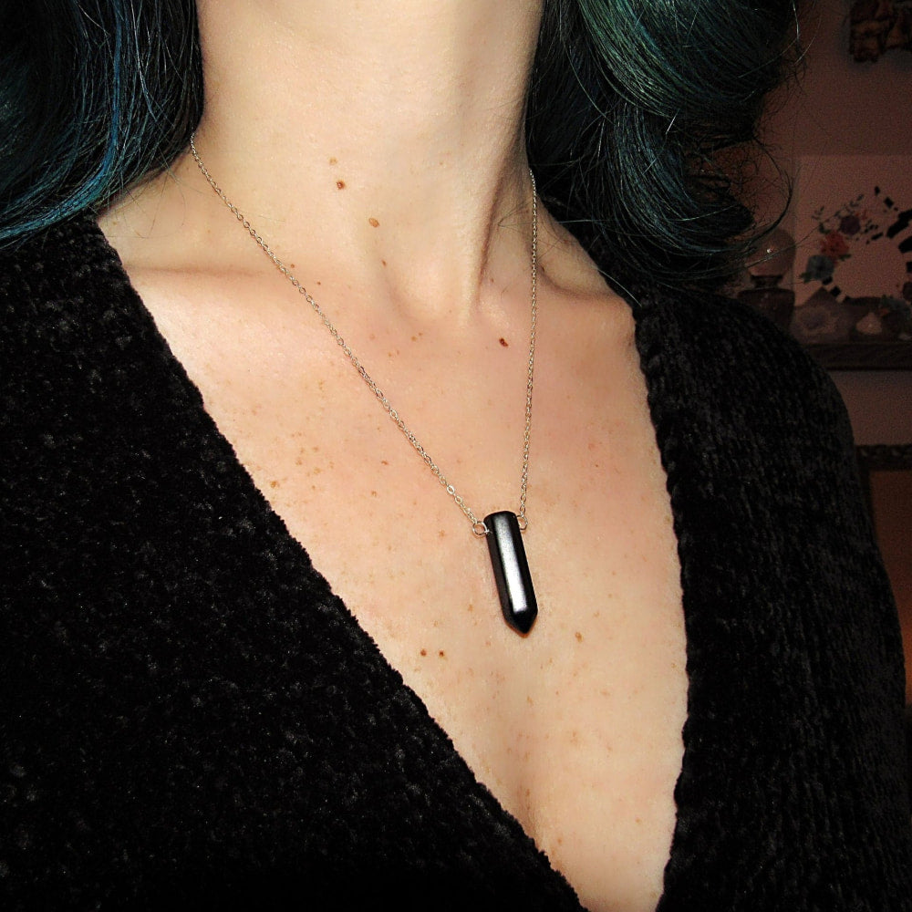 a woman with green hair and a black shirt
