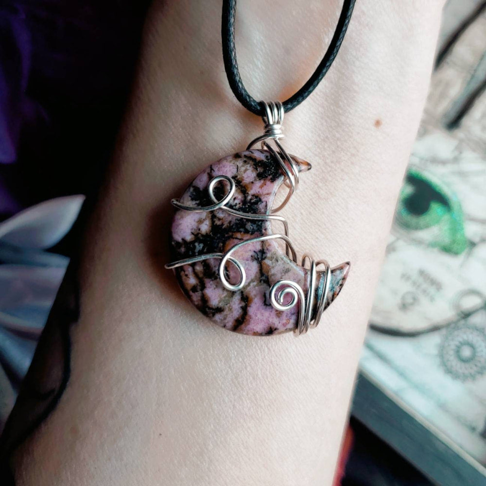 Woman wearing red jasper crescent moon crystal bracelet with pink stone