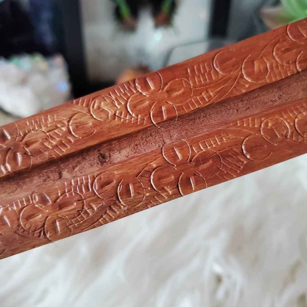 Close-up of carved floral wood incense burner design